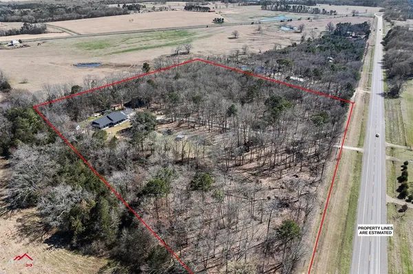 a view of a house with a swimming pool and a yard