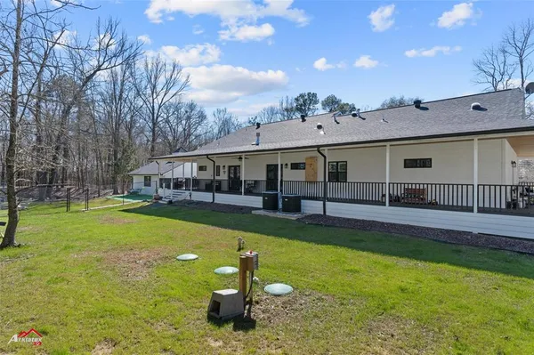 a front view of a house with swimming pool having outdoor seating