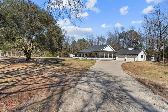 a living room with fireplace furniture and a wooden floor