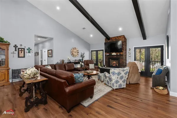a living room with fireplace furniture and a flat screen tv
