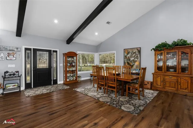 a room with lots of wooden furniture and mirrors