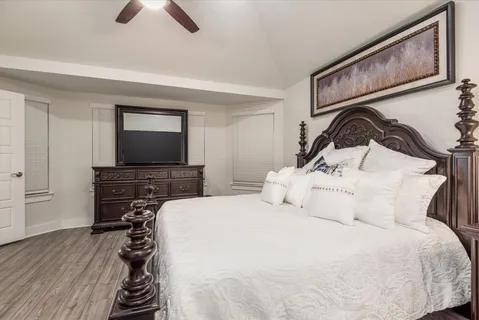 a bedroom with a bed and a flat screen tv
