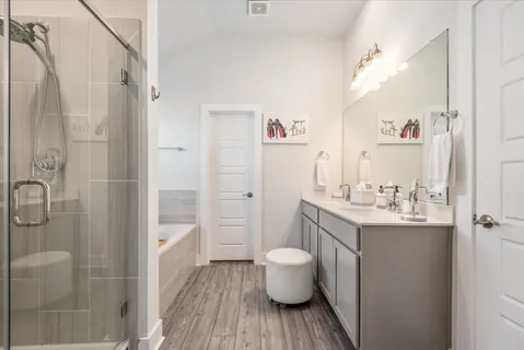 a spacious bathroom with a granite countertop sink toilet a shower and a mirror