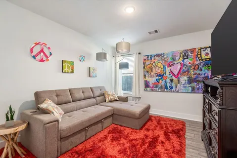a living room with furniture and a flat screen tv