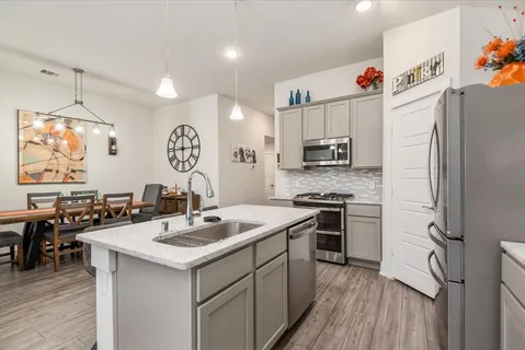 a kitchen with a sink stove and refrigerator