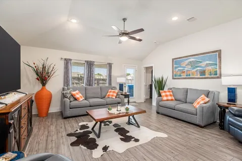a living room with furniture a rug and a flat screen tv