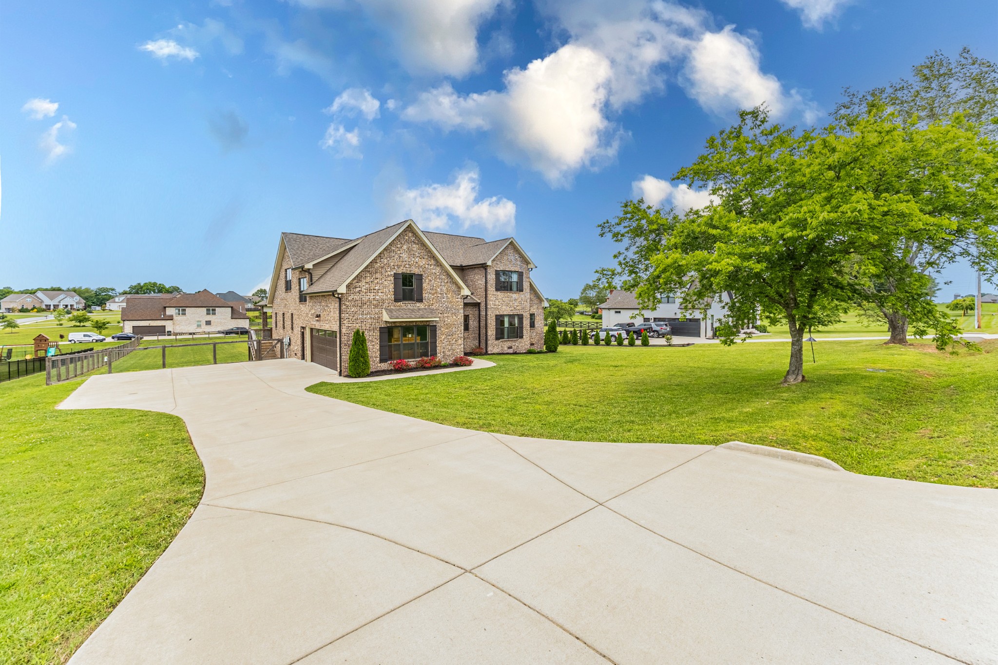 a view of house with garden and tall trees