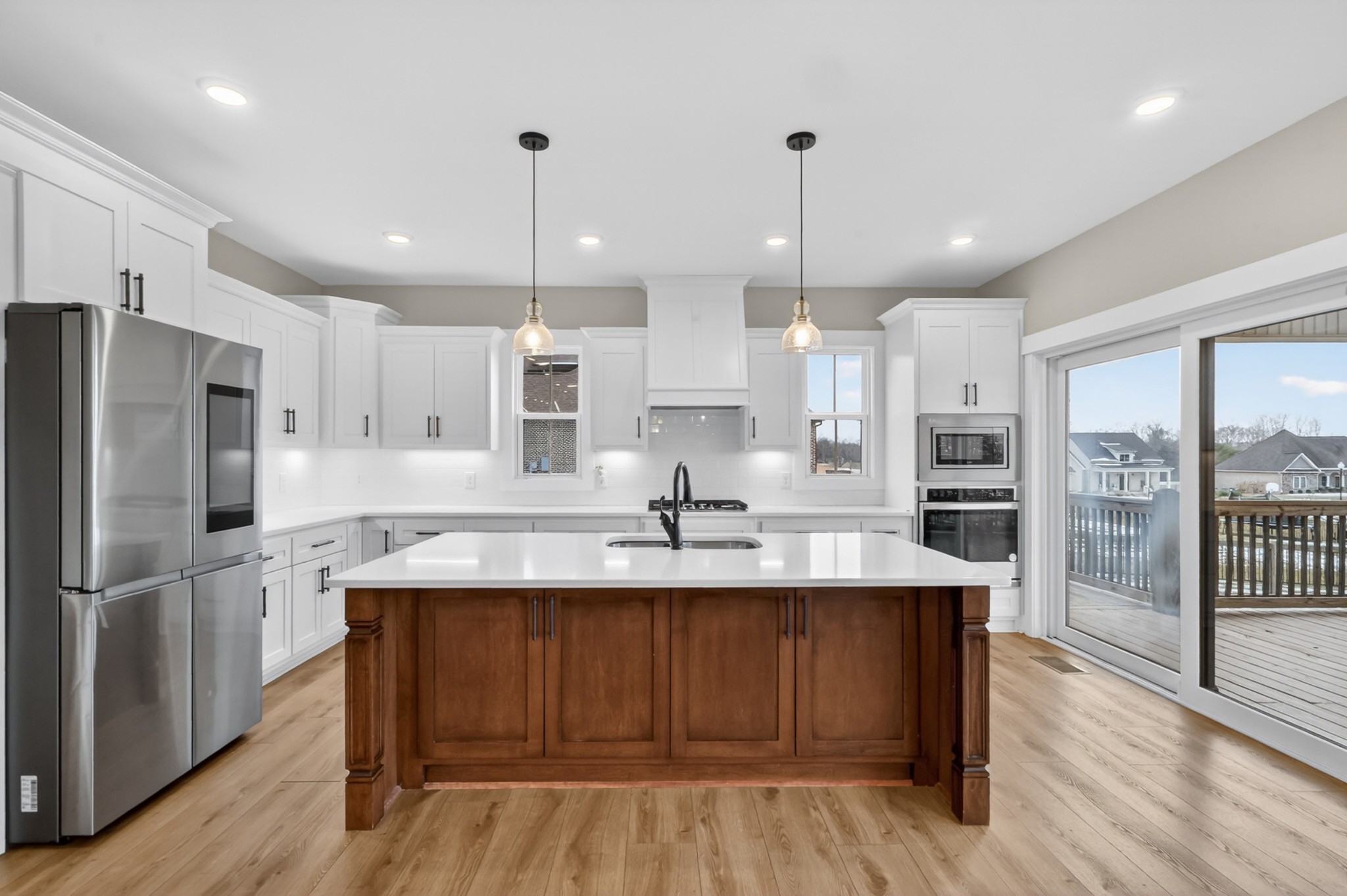 746 North Russell Street Portland, TN 37148 - Photo 16 of 45 a kitchen with kitchen island a island wooden floors stainless steel appliances and cabinets