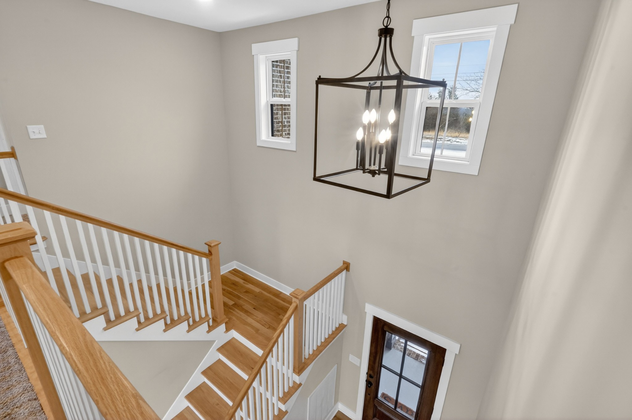 746 North Russell Street Portland, TN 37148 - Photo 29 of 45 a view of staircase with railing and a chandelier