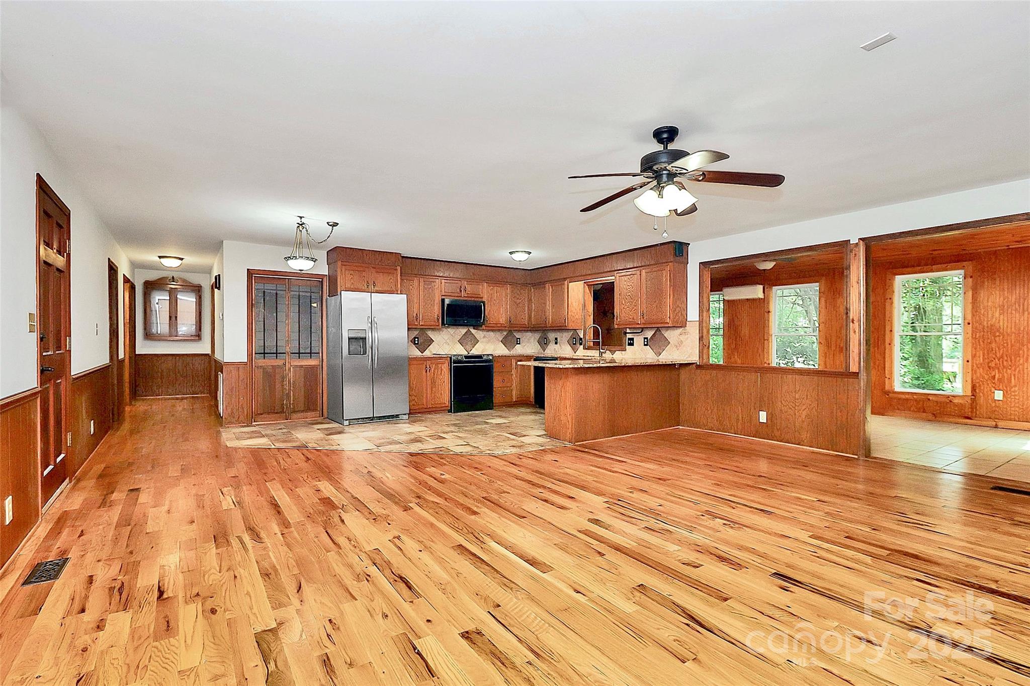 3311 Camden Road Marshville, NC 28103 - Photo 11 of 29 a view of a kitchen with kitchen island a counter top space appliances and a ceiling fan
