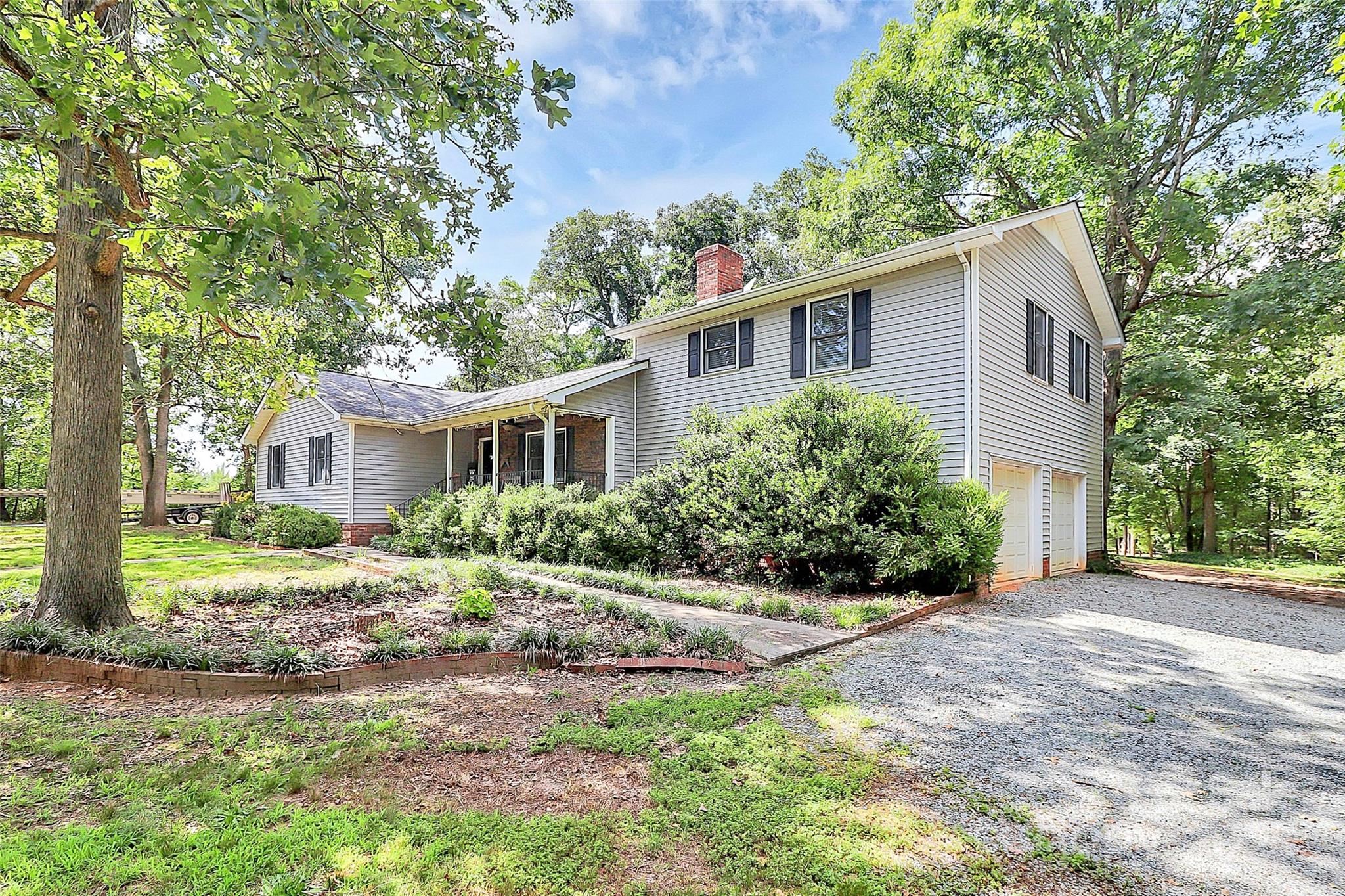 3311 Camden Road Marshville, NC 28103 - Photo 26 of 29 a front view of a house with a yard and potted plants