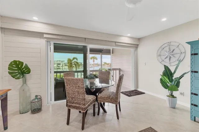 a dining room with furniture and potted plant