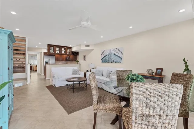 a kitchen with stainless steel appliances granite countertop a kitchen island a stove a dining table and chairs