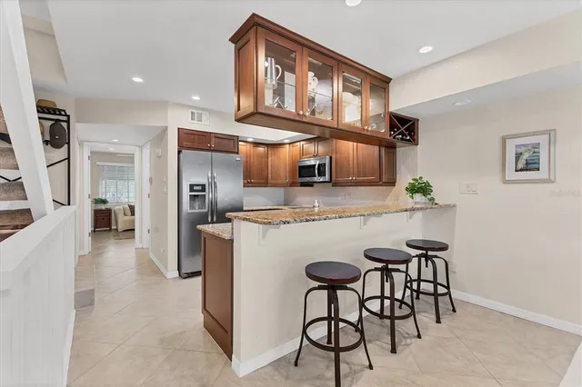 a kitchen with stainless steel appliances granite countertop a stove and cabinets