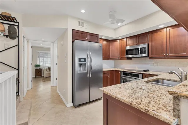 a kitchen with a table chairs stove and cabinets