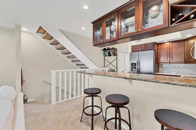 a living room with furniture and a book shelf