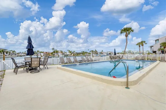 an aerial view of a house with garden space ocean and mountain view in back