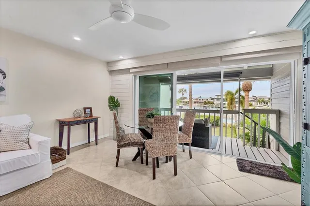a dining room with furniture and a potted plant