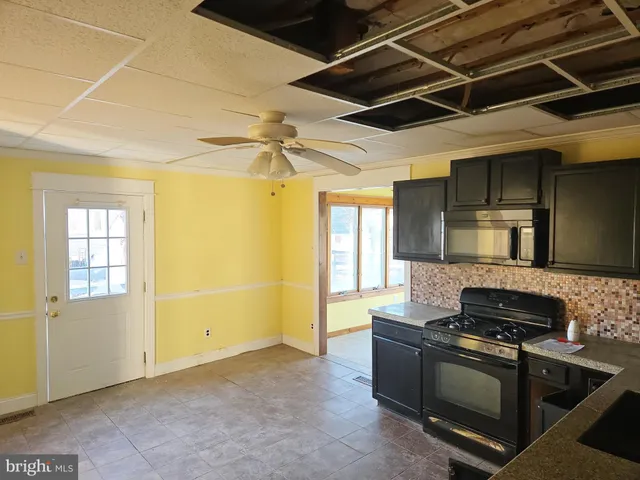 a kitchen with a stove and a refrigerator