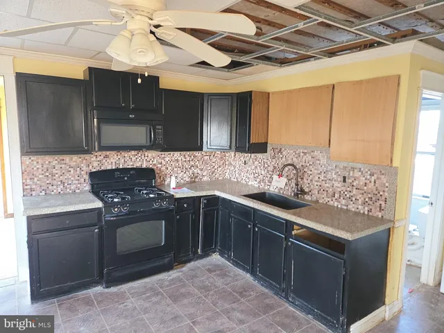 a kitchen with stainless steel appliances granite countertop a stove and a sink