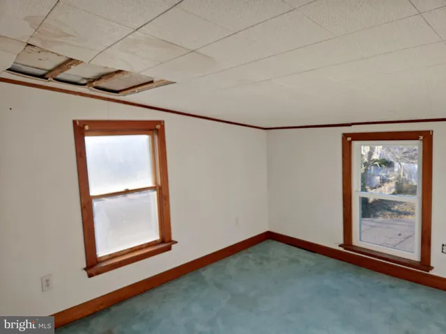 a living room with a bed and a window