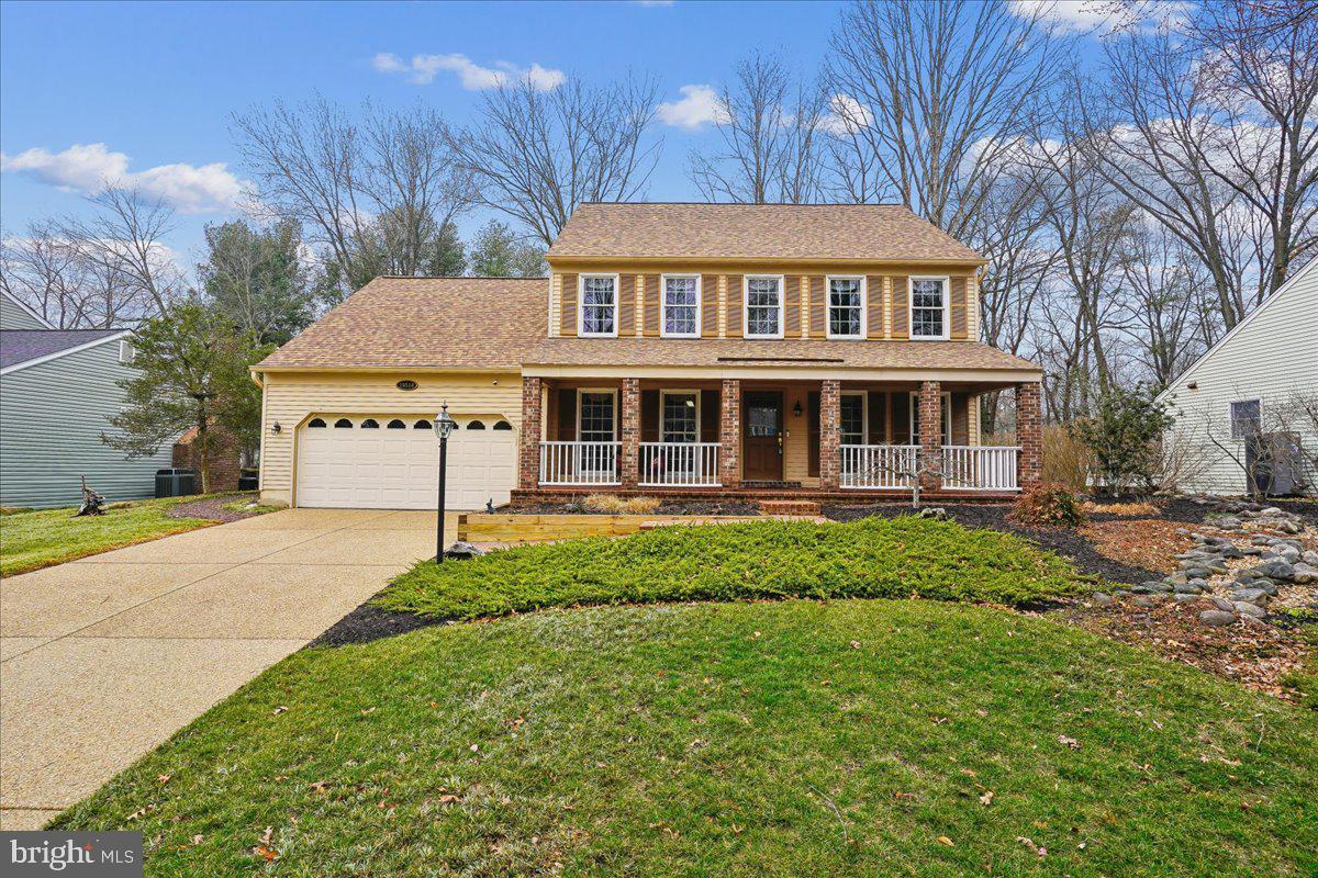 a view of a house with a yard and sitting area