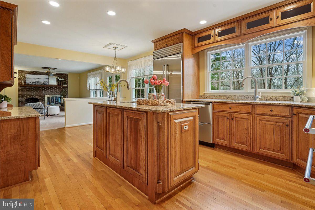 15510 Ridgecrest Drive Dumfries, VA 22025 - Photo 14 of 48 a kitchen with stainless steel appliances granite countertop a sink and wooden cabinets