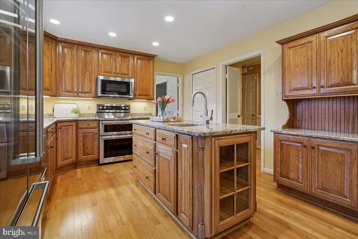 15510 Ridgecrest Drive Dumfries, VA 22025 - Photo 15 of 48 a kitchen with stainless steel appliances a stove sink microwave and cabinets