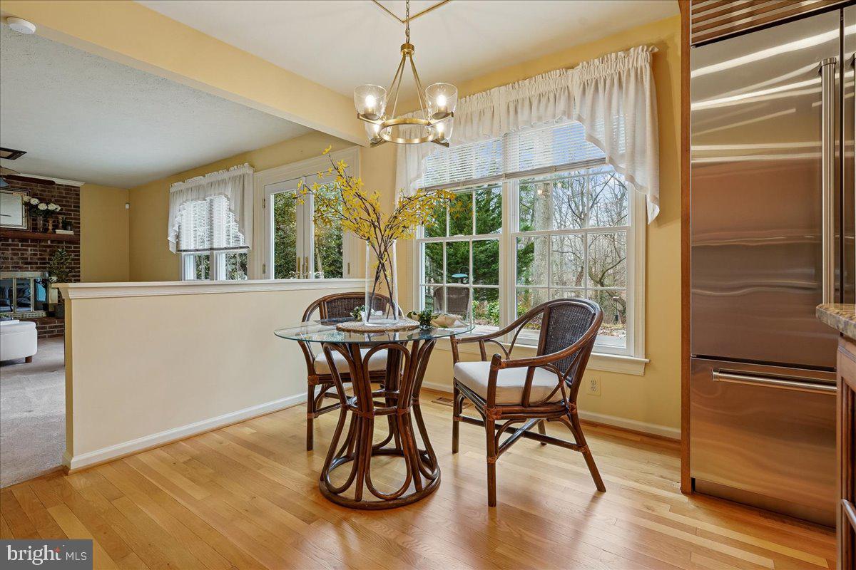 15510 Ridgecrest Drive Dumfries, VA 22025 - Photo 17 of 48 a dining room with furniture a chandelier and wooden floor