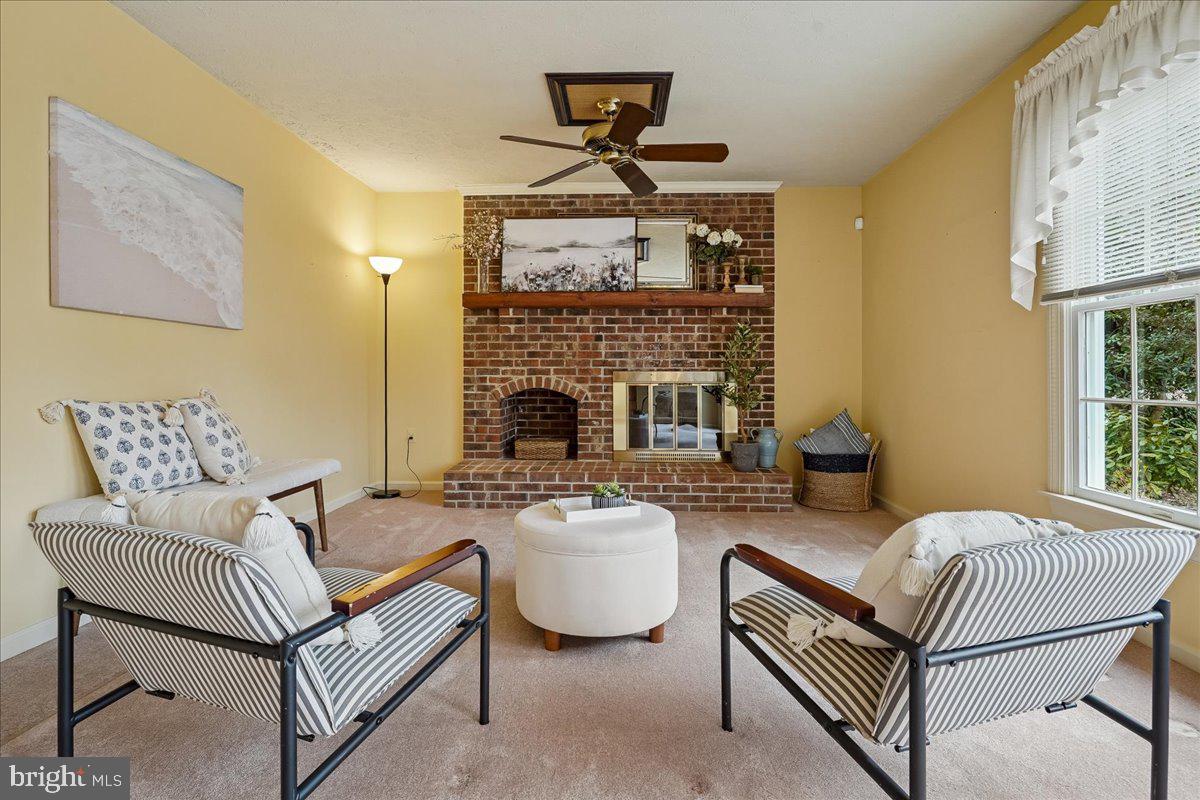 15510 Ridgecrest Drive Dumfries, VA 22025 - Photo 18 of 48 a living room with furniture a fireplace and a table