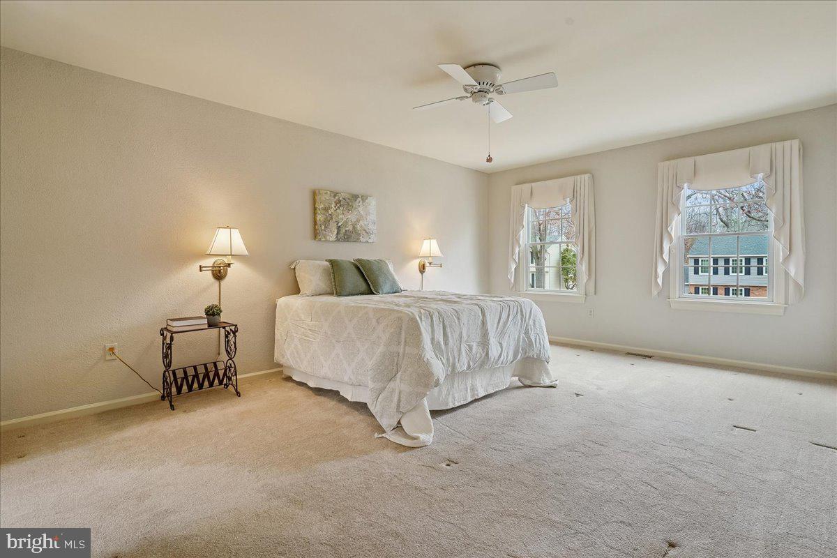 15510 Ridgecrest Drive Dumfries, VA 22025 - Photo 25 of 48 a spacious bedroom with a bed and a chandelier