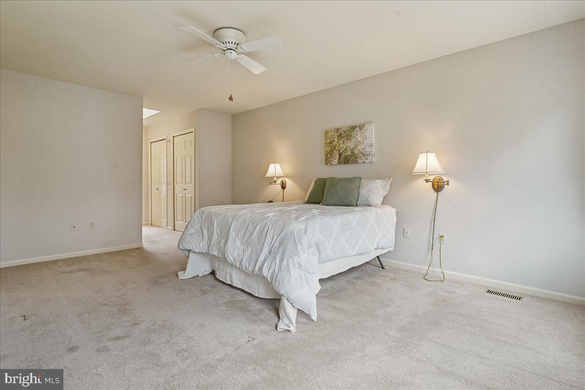 15510 Ridgecrest Drive Dumfries, VA 22025 - Photo 26 of 48 a bedroom with a bed and a chandelier