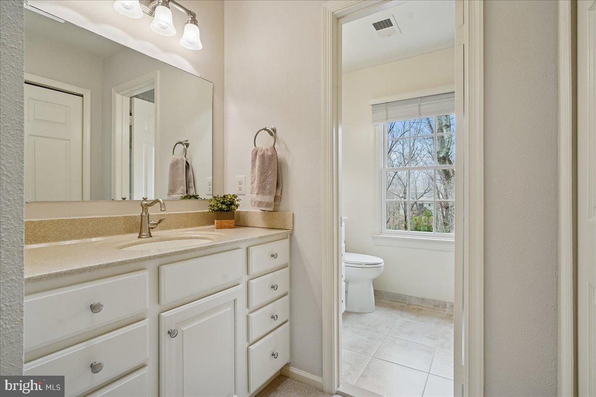 15510 Ridgecrest Drive Dumfries, VA 22025 - Photo 28 of 48 a bathroom with a toilet a sink shower and mirror
