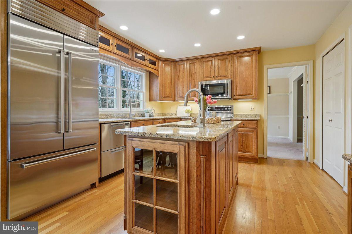 15510 Ridgecrest Drive Dumfries, VA 22025 - Photo 3 of 48 a kitchen with kitchen island granite countertop a refrigerator stove top oven with a sink and dishwasher