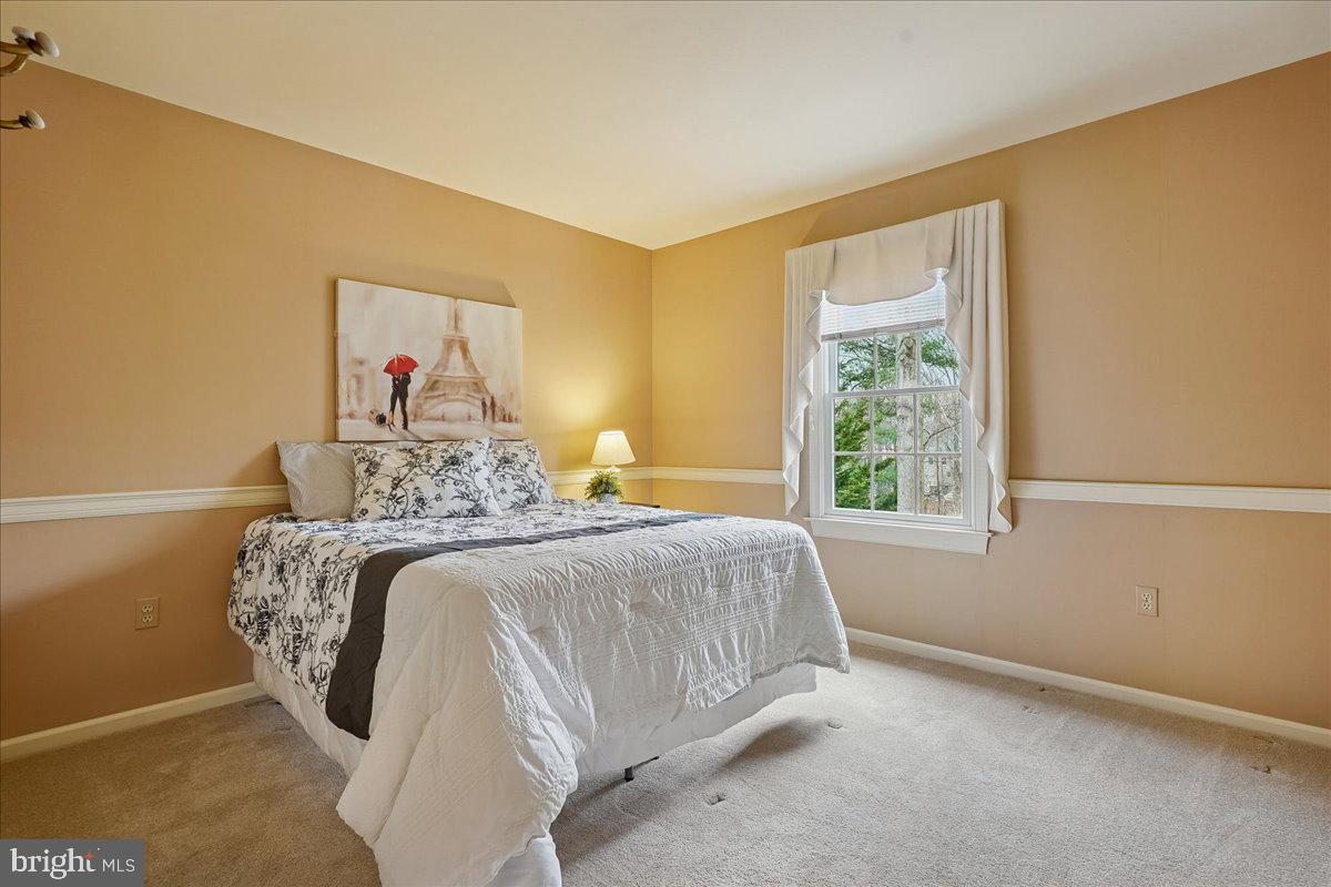 15510 Ridgecrest Drive Dumfries, VA 22025 - Photo 31 of 48 a bedroom with a bed and a window