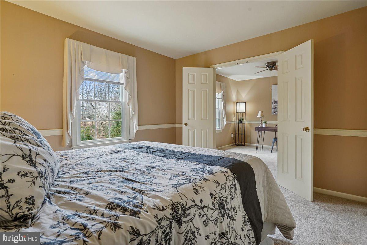 15510 Ridgecrest Drive Dumfries, VA 22025 - Photo 32 of 48 a bedroom with a large bed and a window