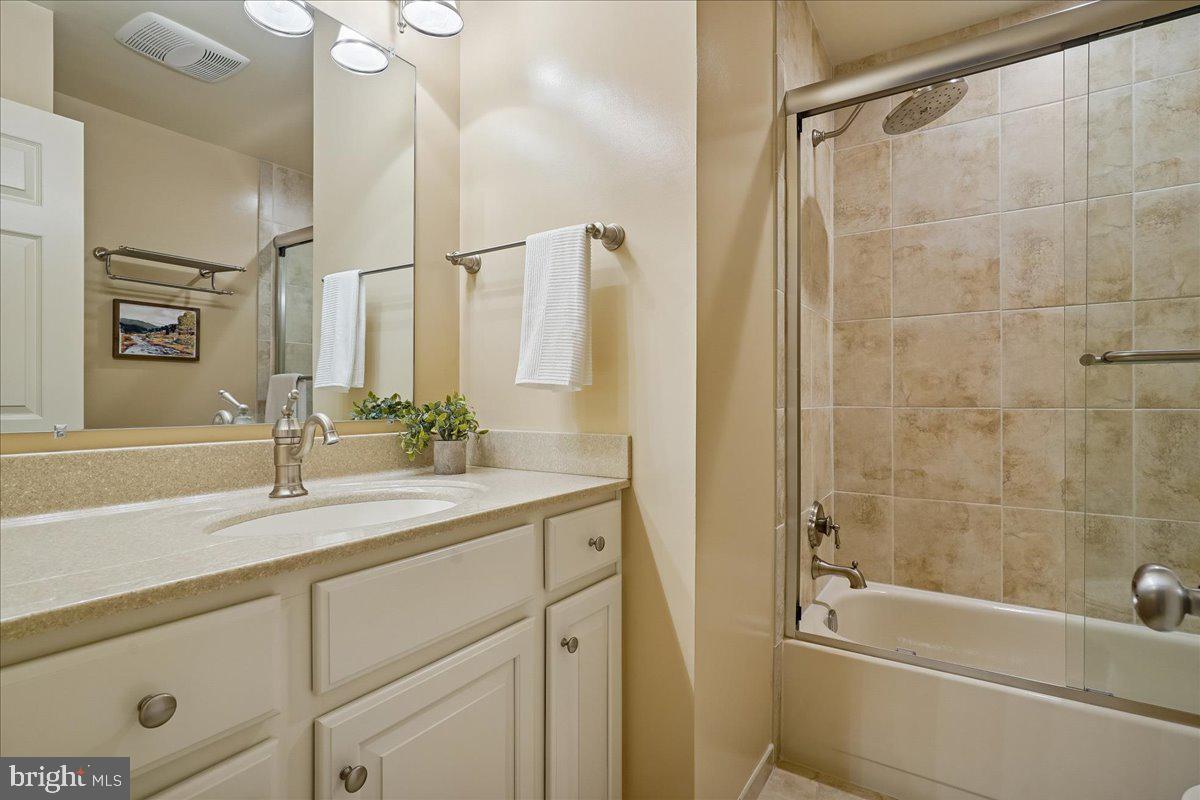 15510 Ridgecrest Drive Dumfries, VA 22025 - Photo 36 of 48 a bathroom with a granite countertop sink a toilet and shower