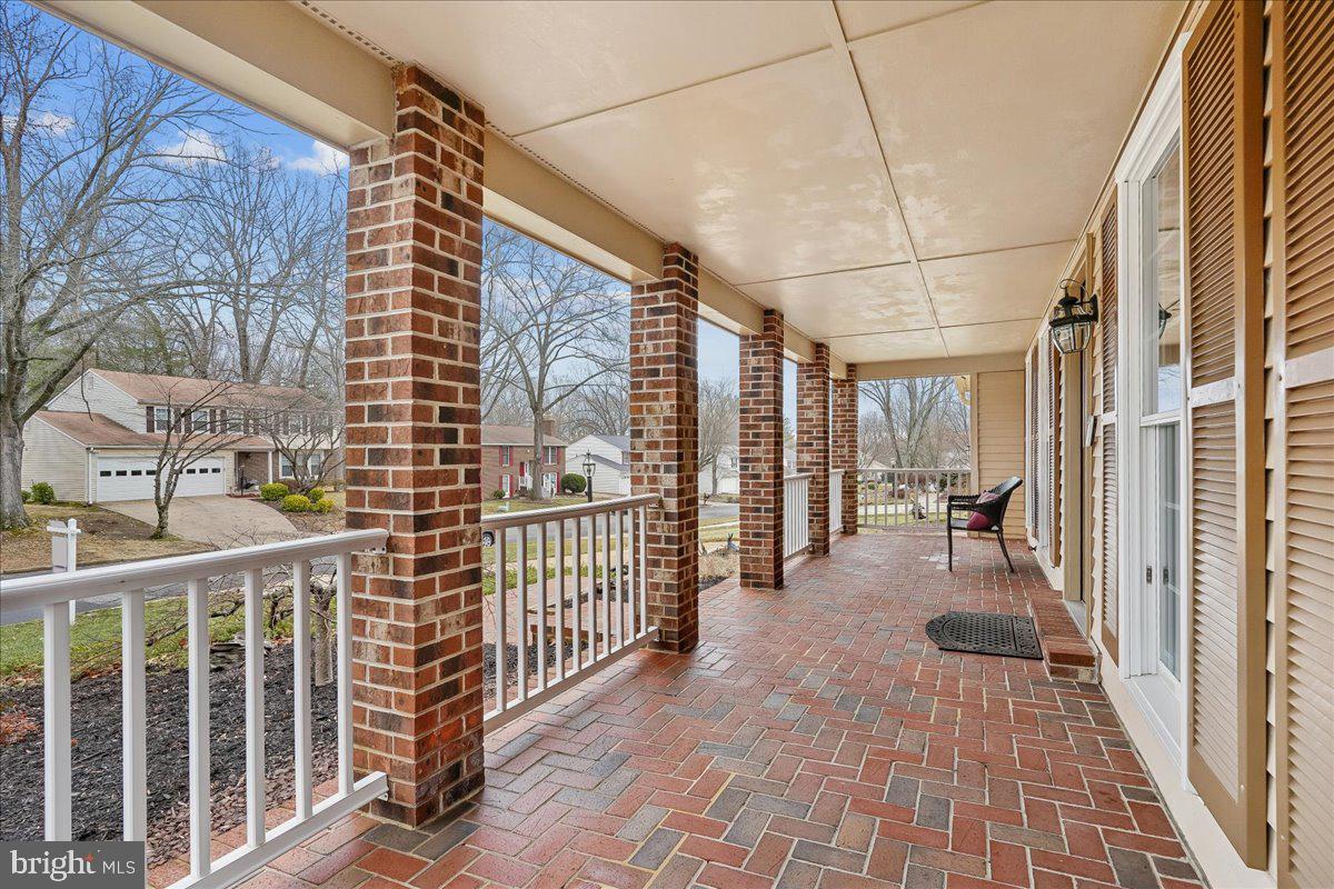 15510 Ridgecrest Drive Dumfries, VA 22025 - Photo 6 of 48 a view of a porch with wooden floor and iron fence