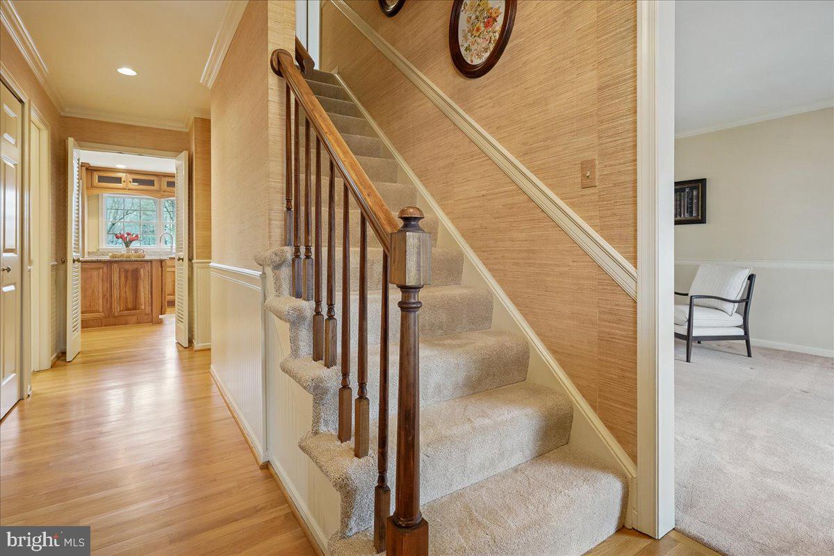 15510 Ridgecrest Drive Dumfries, VA 22025 - Photo 7 of 48 a view of a hallway with wooden floor and staircase