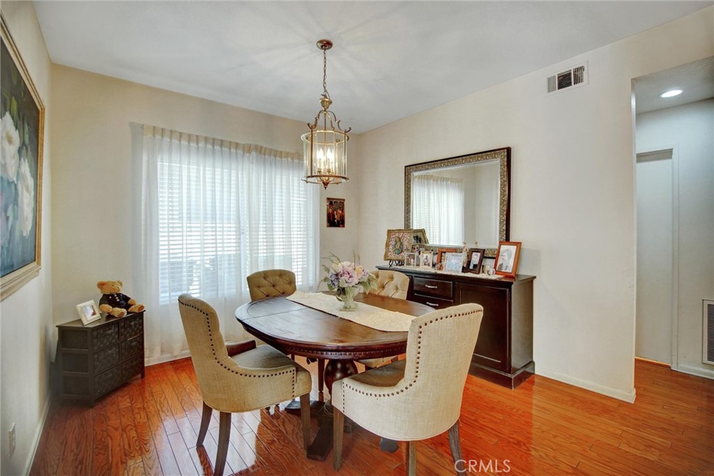 1072 Silvercreek Road Corona, CA 92882 - Photo 15 of 31 a view of a dining room with furniture window and wooden floor