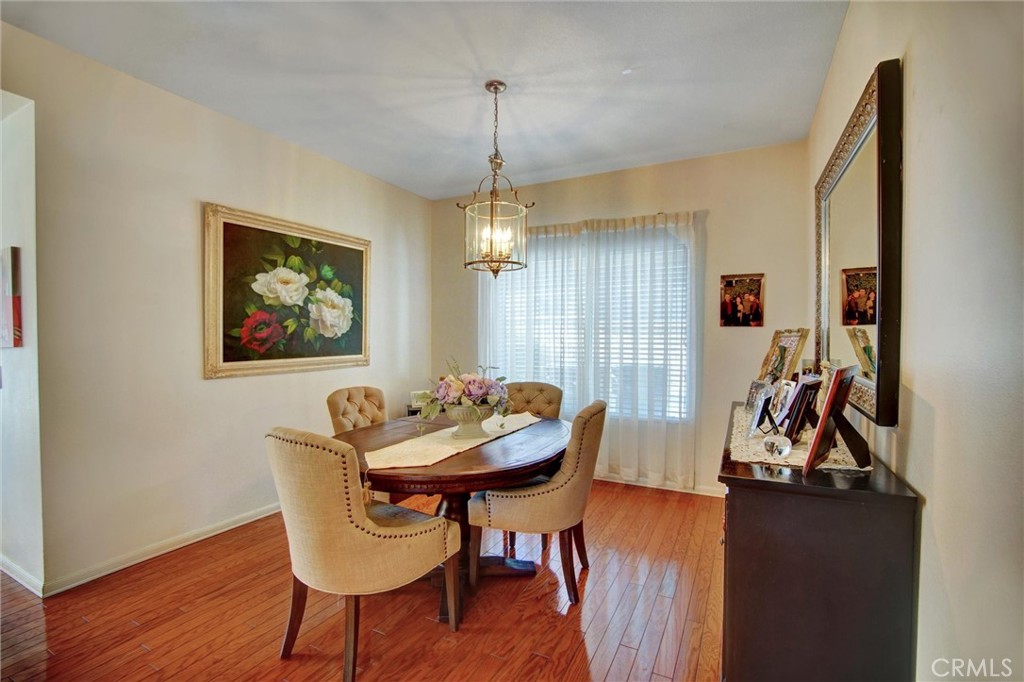 1072 Silvercreek Road Corona, CA 92882 - Photo 16 of 31 a view of a dining room with furniture and wooden floor