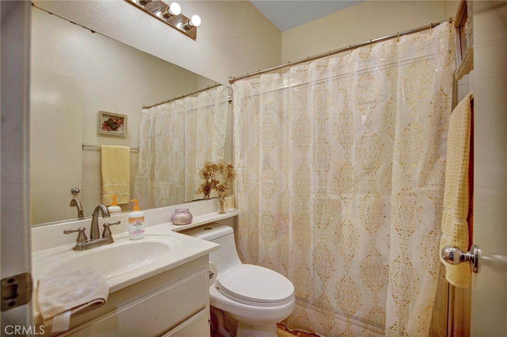 1072 Silvercreek Road Corona, CA 92882 - Photo 17 of 31 a bathroom with a sink a toilet and a mirror
