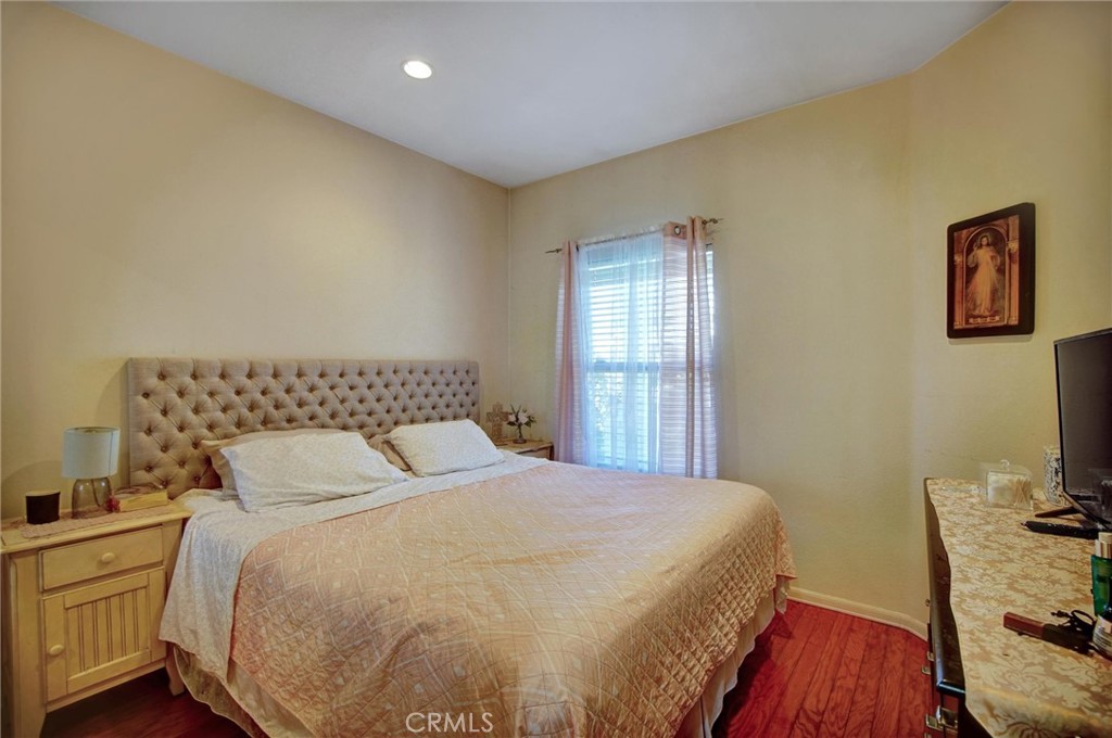 1072 Silvercreek Road Corona, CA 92882 - Photo 18 of 31 a bedroom with a bed and a flat screen tv