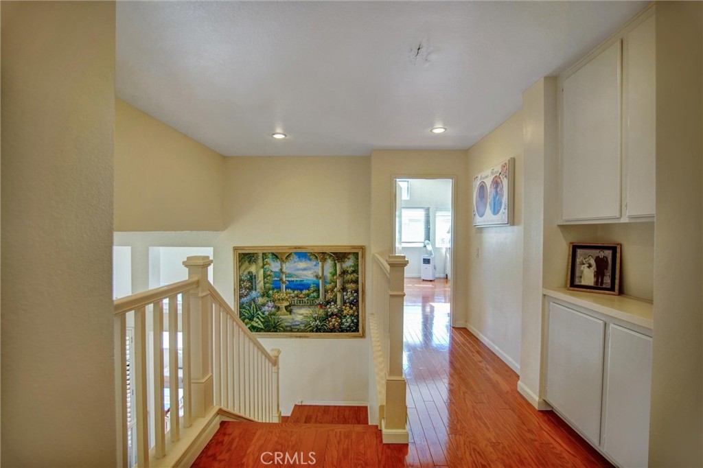 1072 Silvercreek Road Corona, CA 92882 - Photo 21 of 31 a view of a hallway with wooden floor and dining room