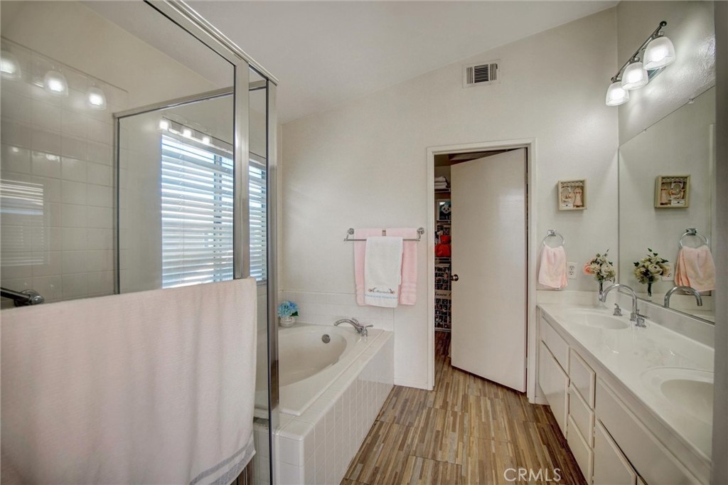 1072 Silvercreek Road Corona, CA 92882 - Photo 26 of 31 a spacious bathroom with a tub shower and a sink