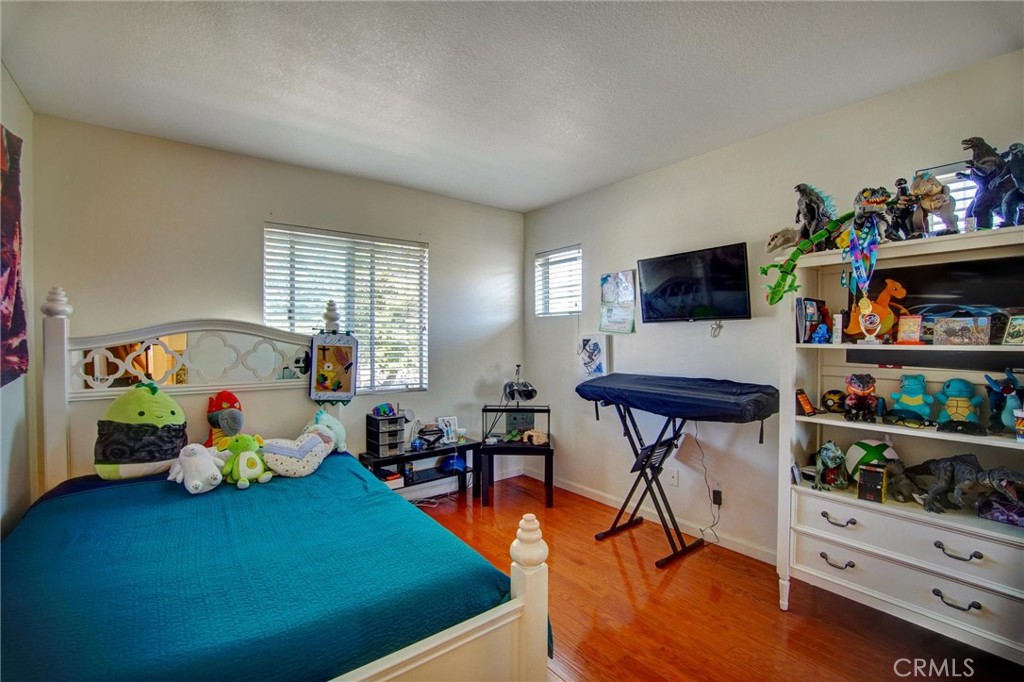1072 Silvercreek Road Corona, CA 92882 - Photo 30 of 31 a living room with furniture and a book shelf