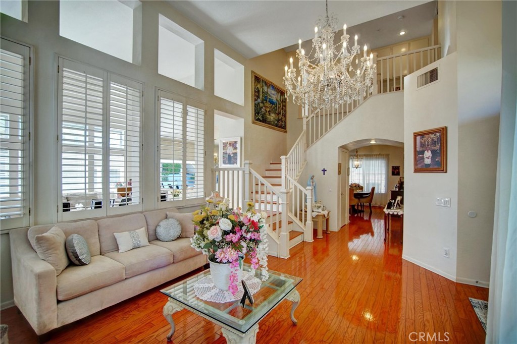 1072 Silvercreek Road Corona, CA 92882 - Photo 9 of 31 a living room with furniture and a chandelier