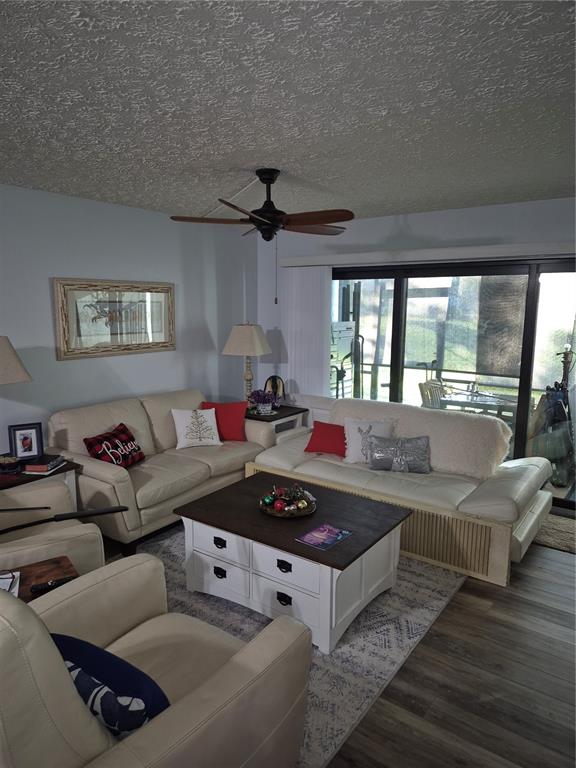 7614 Radcliffe Circle, Unit 104B Port Richey, FL 34668 - Photo 11 of 17 a living room with furniture and a large window
