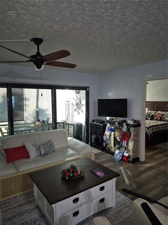 7614 Radcliffe Circle, Unit 104B Port Richey, FL 34668 - Photo 12 of 17 a living room with furniture and a flat screen tv