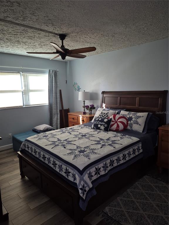 7614 Radcliffe Circle, Unit 104B Port Richey, FL 34668 - Photo 13 of 17 a bed sitting in a bedroom next to a window